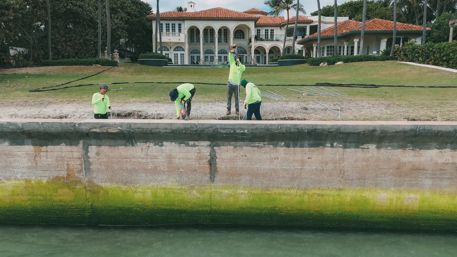 Crew walking an estate seawall cap